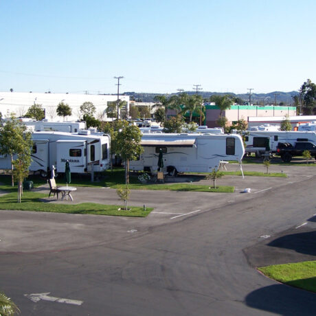 An image showing the spacious full-service RV sites, nestled among the lush orange groves at Orangeland RV Park in Orange, CA.