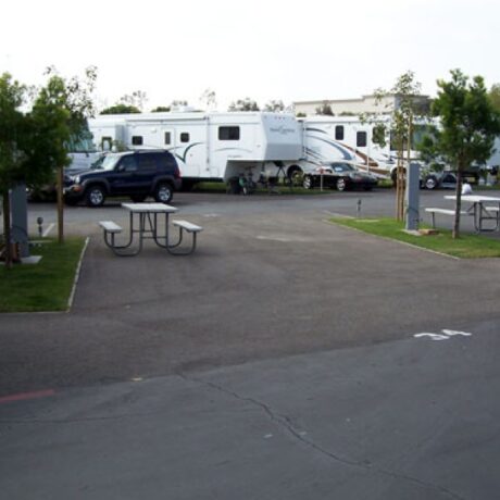 An image showing the spacious full-service RV sites, nestled among the lush orange groves at Orangeland RV Park in Orange, CA.
