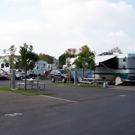 An image showing the spacious full-service RV sites, nestled among the lush orange groves at Orangeland RV Park in Orange, CA.