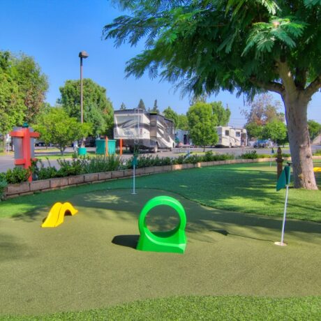 A family enjoying a round of mini-golf at Orangeland RV Park in Orange, CA.