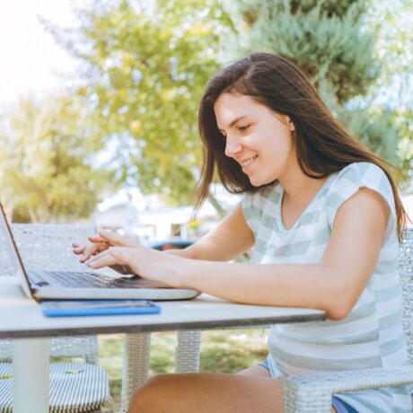 A woman using laptop at Orangeland RV Park in Orange, CA